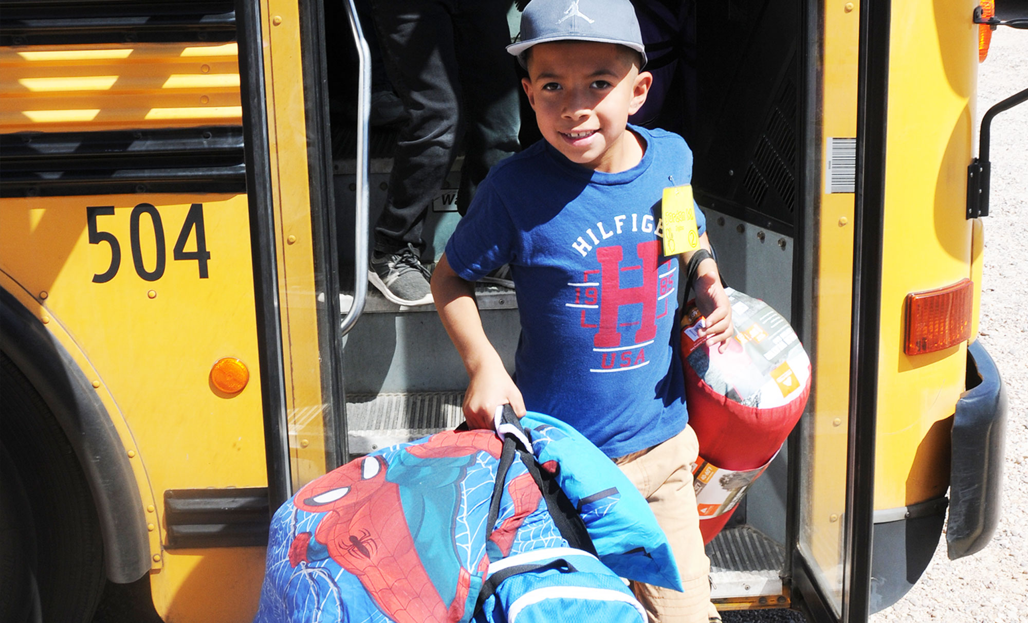 Camp Cooper overnights are unforgettable - picture of student arriving with overnight gear.