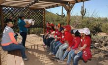 Photo of children learning in the desert.